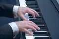 Man`s hands playing on a piano at the concert Royalty Free Stock Photo