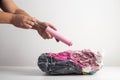 Man& x27;s hands pump air out of a sealed bag with a hand pump. Vacuum bags for storing things and clothes. Copy space Royalty Free Stock Photo