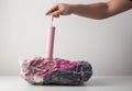 Man& x27;s hands pump air out of a sealed bag with a hand pump. Vacuum bags for storing things and clothes. Copy space Royalty Free Stock Photo