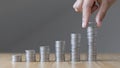Man`s hands put the coins arranged in steps, Managing your finances or saving money for future use, Saving for investment