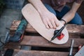 Man`s hands screwing bolts into skateboard truck