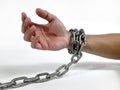 a man's hands shackled by chains