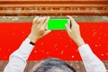 Man`s hands shooting with phone empty green screen red carpet Royalty Free Stock Photo