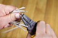 Man's hands stripping insulated wires