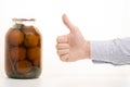 Man`s hands tomatoes in a jar