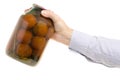 Man`s hands tomatoes in a jar