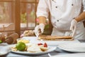 Man's hands touch shortcake dough.