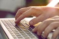 Man`s hands typing on laptop keyboard.