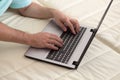 Man`s hands typing on laptop notebook keyboard at home. Man browsing information on internet. Freelance blogging, it