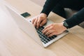 Man`s hands using laptop with blank screen on desk in home interior. Mockup image white screen Royalty Free Stock Photo