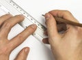 Man's hands are using pen and ruler on the white paper Royalty Free Stock Photo