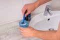 Man`s hands washing a razor in the cup with water Royalty Free Stock Photo