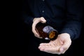 The man`s hands, in which there is a jar of omega 3 capsules, he pours them into the palm of his hand fish oil Royalty Free Stock Photo