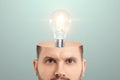 In the man`s head, an incandescent lamp symbolizes an idea. The concept is a fresh look, a new idea, a creative solution, thinkin