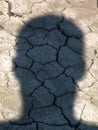 Man`s head shadow on dry earth