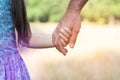 Man`s and kid`s hands. Father leads his child, summer nature outdoor. Parenting, togetherness, help, union, childhood, trust,