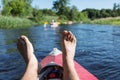Man's legs over canoe.