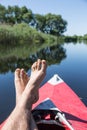 Man's legs over canoe. Royalty Free Stock Photo