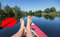 Man's legs over canoe.