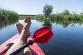 Man`s legs over canoe.