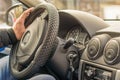 Man`s male hand of the driver on the steering wheel of the car Royalty Free Stock Photo