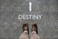 Man`s shoes view from above, word destiny and an arrow indicating the direction with copy space for your text Royalty Free Stock Photo