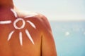 Man`s shoulder and suncream on it