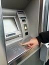Man`s using the ATM machine with cash cards. Close-up of hand entering PIN/pass code on ATM/bank machine keypad Royalty Free Stock Photo