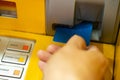 Man& x27;s  Using Card To Withdraw Money inserting a credit card in the ATM Royalty Free Stock Photo