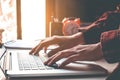 Man`s using laptop on desk in home interior. Business concept