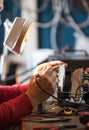 Man with safety glasses repairing motheboard with soldering iron