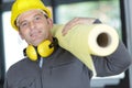 man safety hat carrying insulating roll Royalty Free Stock Photo