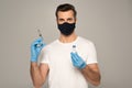 Man in safety mask and latex gloves holding jar of vaccine and syringe Royalty Free Stock Photo