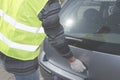Man in a safety vest is opening boot in his car Royalty Free Stock Photo