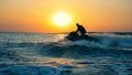 A man is sailing across the sea on his waverunner.