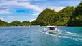 Man sailing a boat in a huge river surrounded by hills in the Philippines