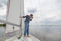 Man is sailing yacht and looking through binoculars Royalty Free Stock Photo
