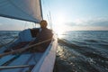 A man on a sailing yacht at sunset, a solo boat trip Royalty Free Stock Photo