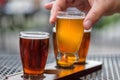 Man sampling beer flight at an outdoor taphouse