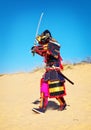 Man in samurai costume with sword running on the sand. Men in sa Royalty Free Stock Photo