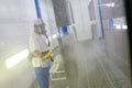 Man sandblasting metal grid