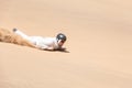 Man sandboarding in Swakopmund Royalty Free Stock Photo