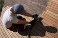 Man sanding and cleaning wooden deck with the power sander Royalty Free Stock Photo