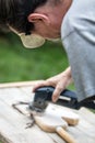 Man is sanding an old hobbyhorse