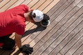 Man sanding weathered grey ipe surface, deck boards before and after Royalty Free Stock Photo