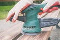 Man sanding a wood with orbital sander Royalty Free Stock Photo