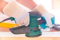 Man sanding a wood with orbital sander Royalty Free Stock Photo