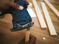 Man sanding wood with square sander in a workshop. Royalty Free Stock Photo