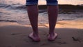 A man on a sandy shore slowly walks into the water Royalty Free Stock Photo