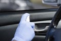 Man sanitizing salon of his car. Male hand in protective glove holding sanitizer closeup